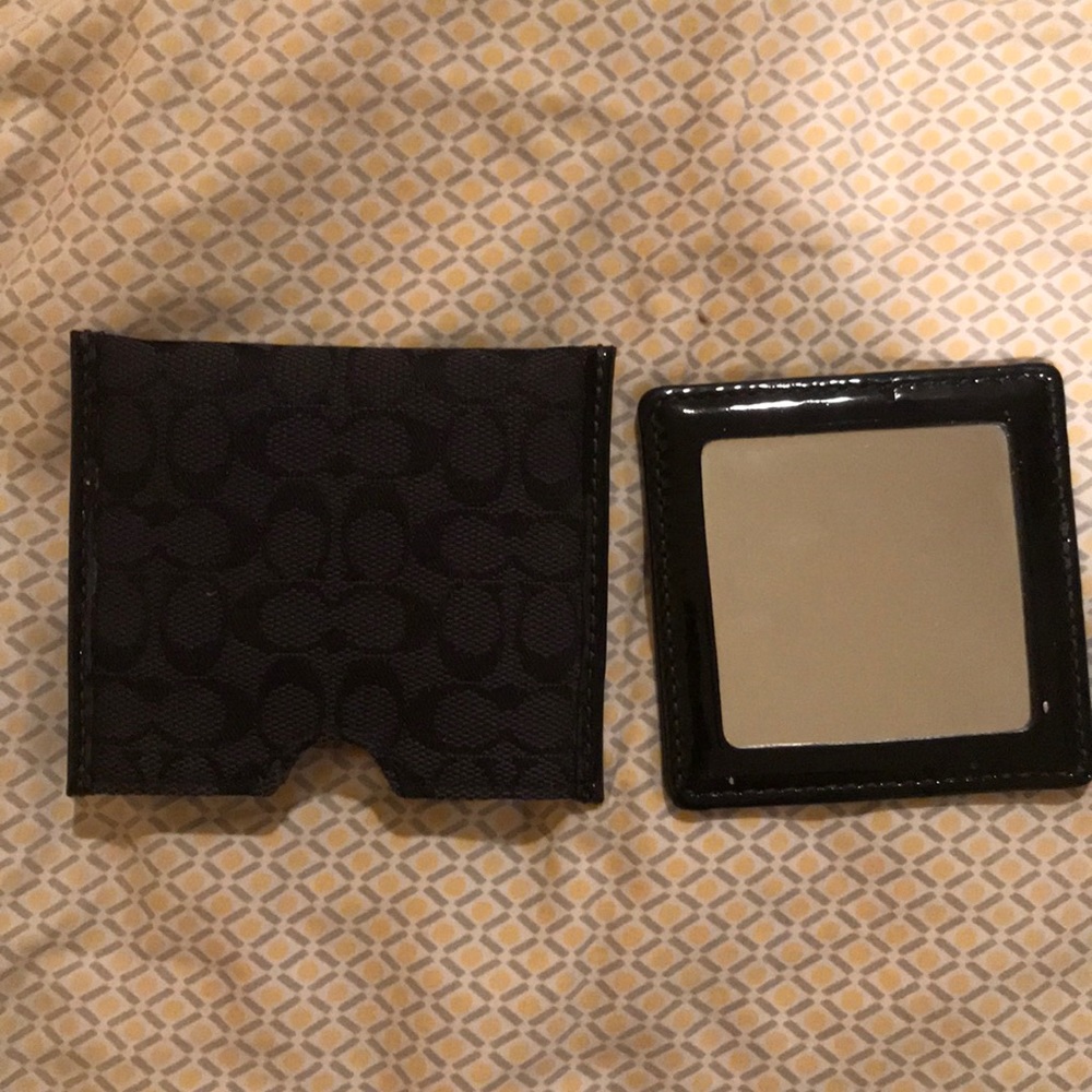 Coach mirror with pouch